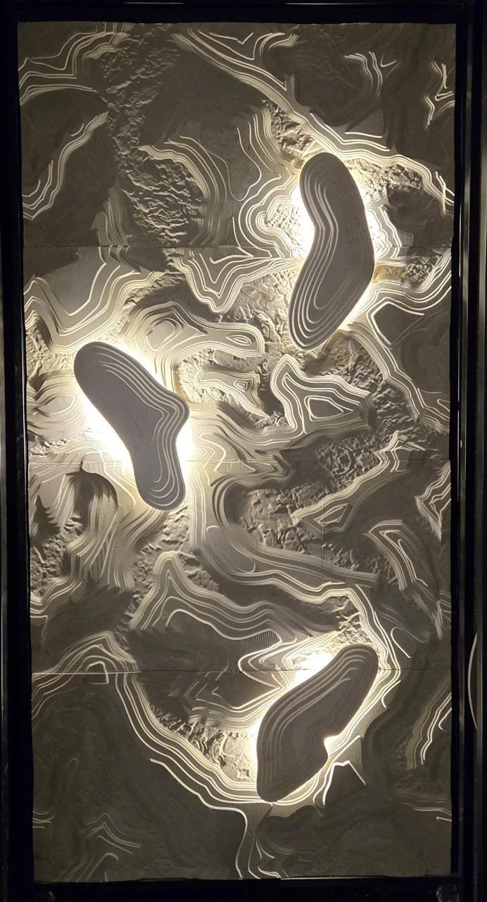 Contour relief, backlit — carved in beige limestone