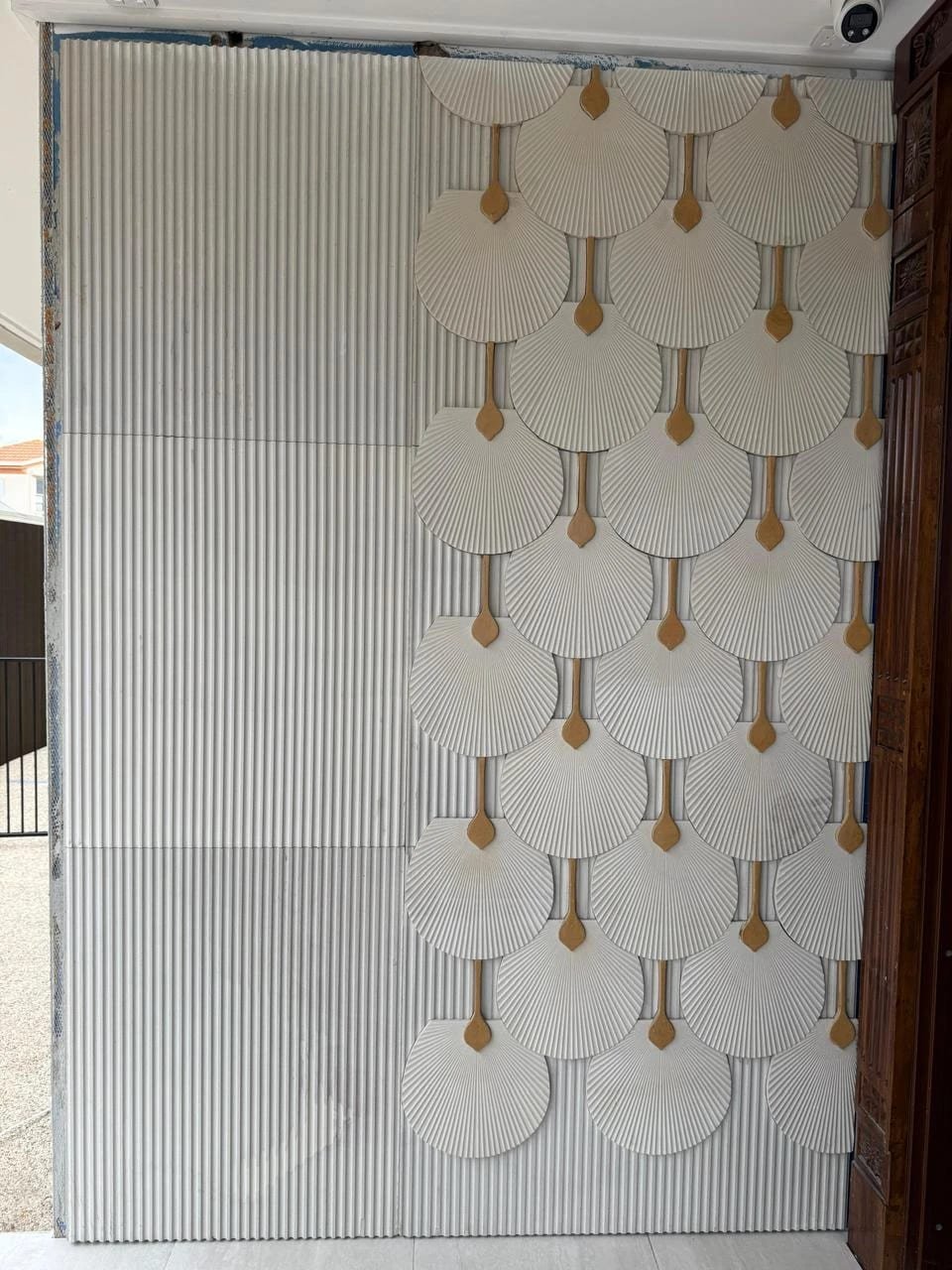 Full-height carved marble and brass feature wall suitable for a hospitality interior